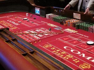 The craps table features various critical sections, each serving distinct roles in gameplay: