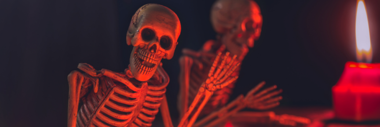 An animated skeleton waves, its skull illuminated by a pulsating red glow.